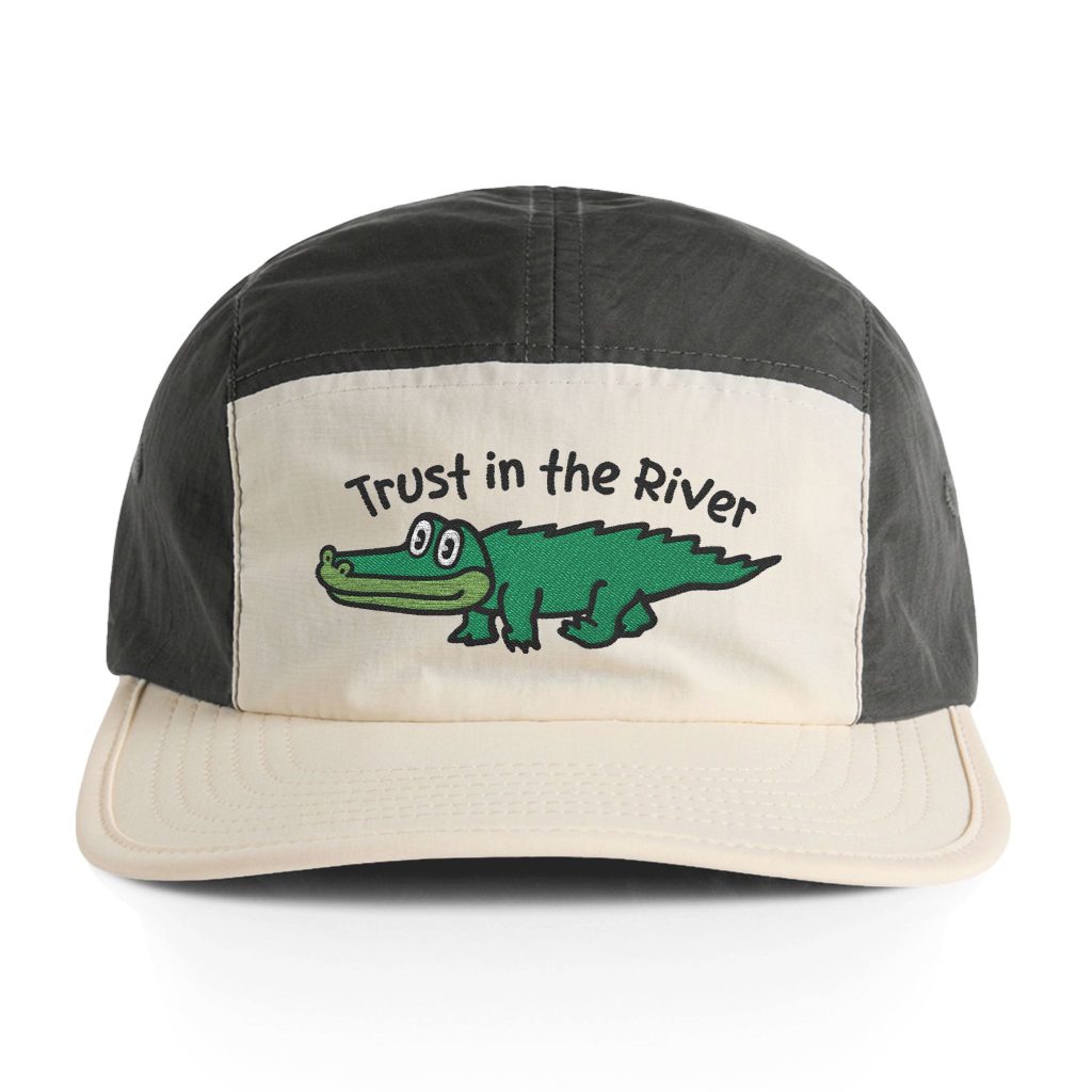 The King Gizzard and the Lizard Wizard Gator Guy embroidered onto a grey and cream colored ballcap, accompanied by the words "Trust in the River"